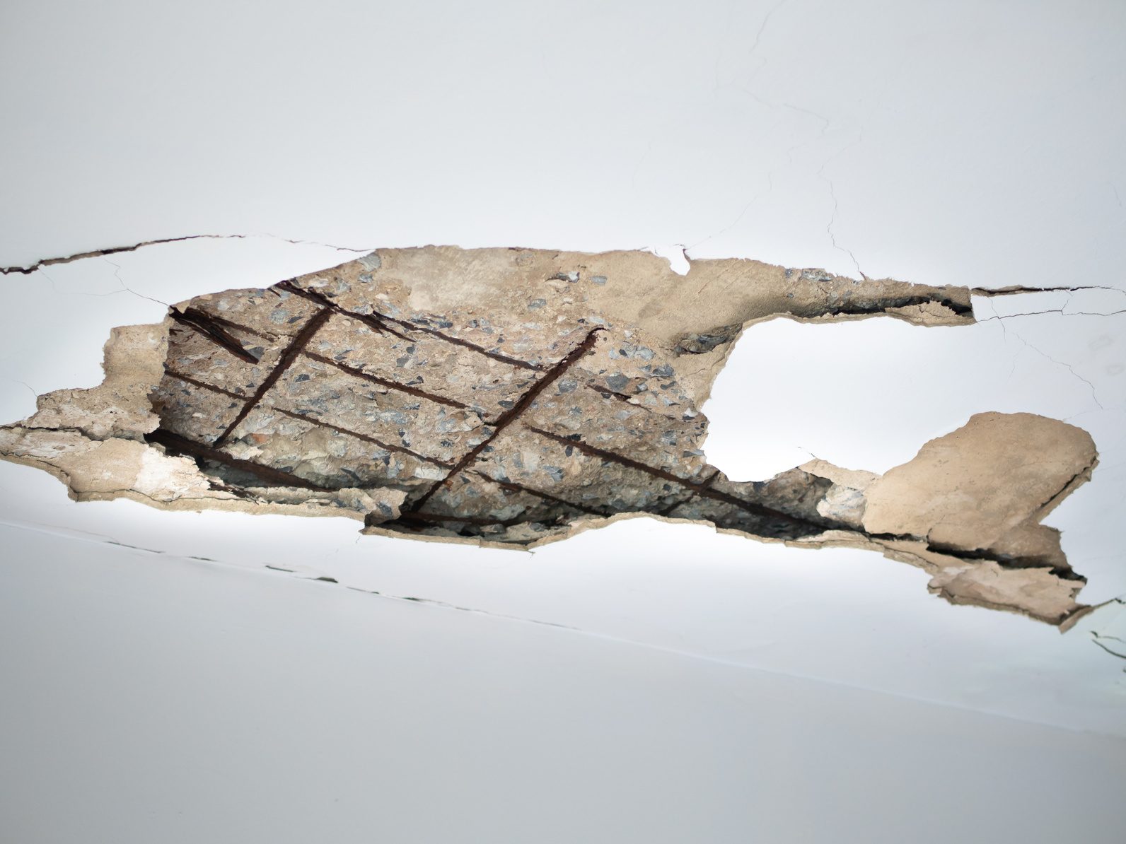 Cracked and broken ceiling plaster from a leaking pipe